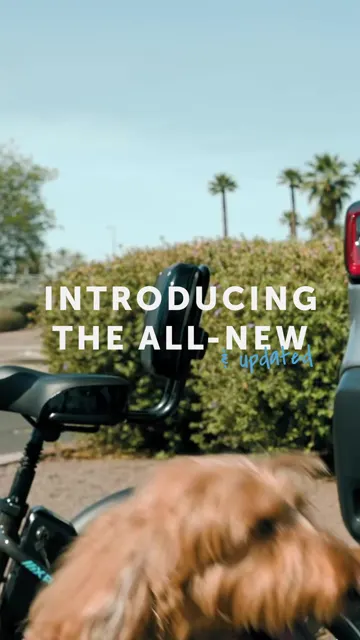 Cover frame of Lectric's pet trailer video: a fluffy dog in front of an e-bike, with the words Introducing the all-new