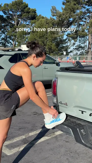 HOKA video of a runner lacing up on a truck tailgate, captioned 'Can't talk right now'. HOKA's most-viewed recent post.